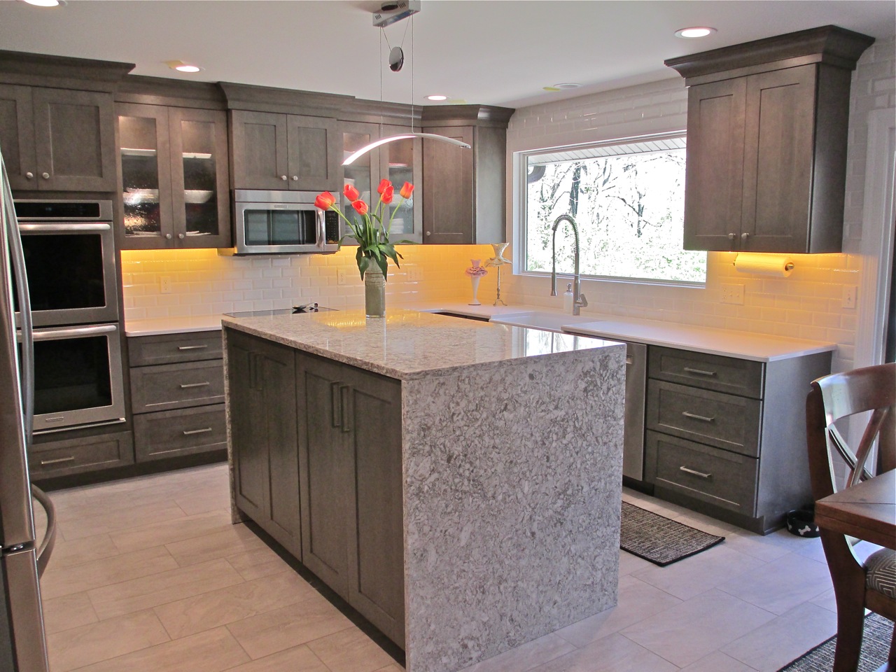 Glossy 3x6 white subway tile seen in the classic offset pattern with white grout. Designed by Carolyn Beard