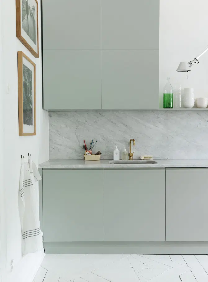 Distinctly modern, green cabinets pair so nicely with white marble. So serene . . . Ommmmmm . . . Image via Swedish Elle Decoration