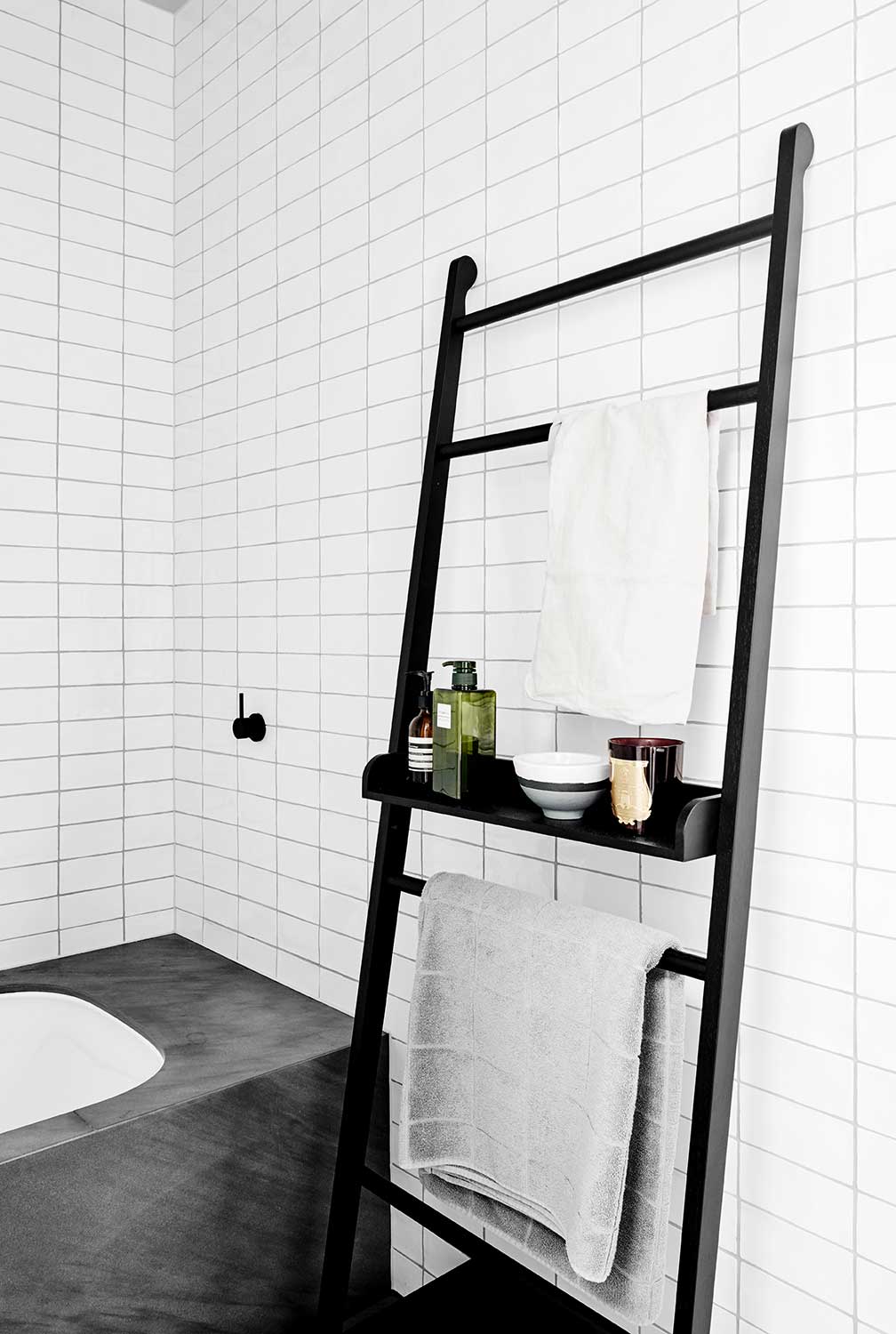 Stacked subway tile with dark grout for a modern industrial look. Image via Flack Studio