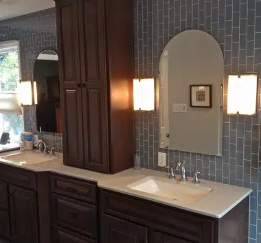 Vertical subway tile with arched mirrors and center tower