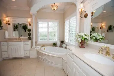 Vanity sconces and chandelier over the tub