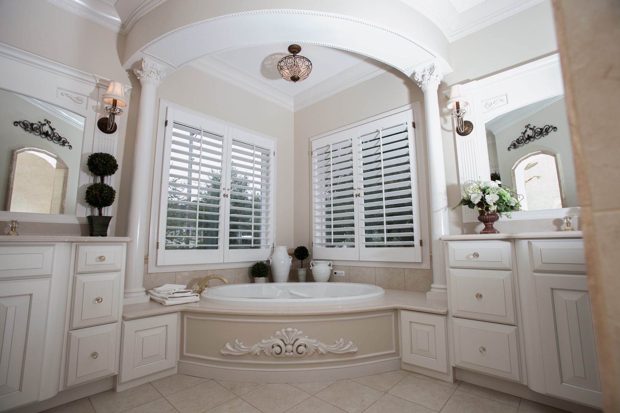 The oval tub follows the curves of the tub deck and soffit with beautiful detailed onlay on curved tub skirt