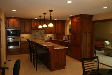 Deco Back splash tile with gold insets, Cherry wood cabinetry and two tiered island