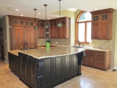 Stacked cabinetry with mullion doors and lighted interiors 