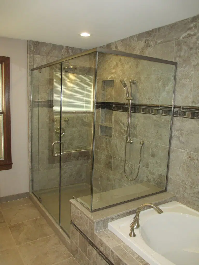 Frameless shower enclosure with floor to ceiling tile 