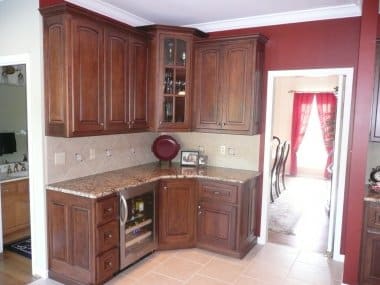 Staggered cherry cabinetry with mullion corner cabinets 