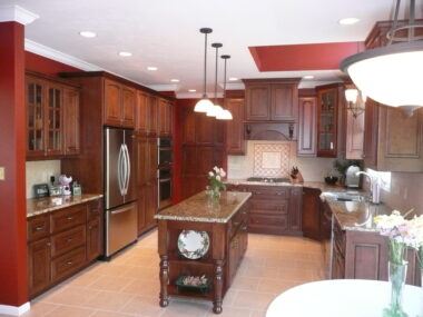 Open ended island with turned legs and pendent lighting over the island 