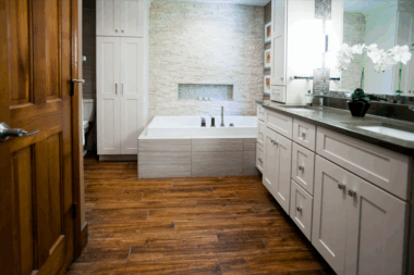 Wood - look plank tile flooring brings warmth to this elegant master bath 