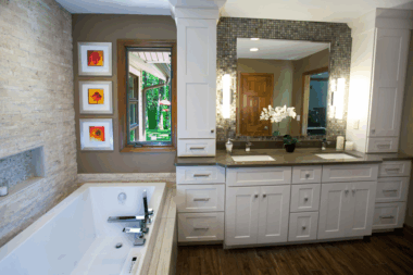 Square tub, faucetry, and vanity bowls keep with the boxy look of the cabinets. 