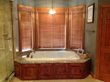Drop in tub in bay window with rustic alder tub skirt 