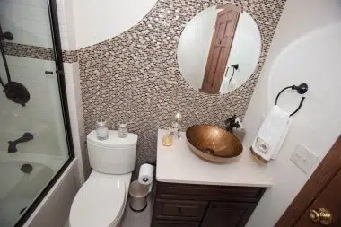 Beautiful sweeping tile adding personality to guest bathroom
