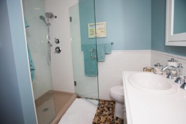 Stone floors with standing, glass door shower