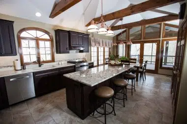 The perimeter of the kitchen has quarts counters and the island has a granite top. 