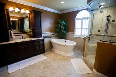 Separate freestanding tub in this large traditional master bathroom