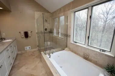 Glass enclosed frameless shower with bench. 