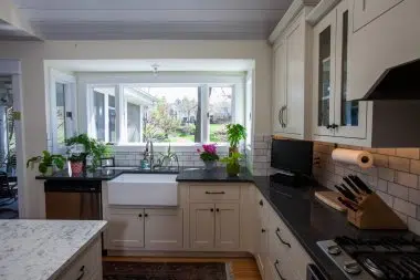 white apron front sink under large window 